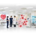 iPS心筋シート「リハート」の医療現場。医療スタッフが治療法に関して話し合う姿を捉えた明るい雰囲気の風景です。